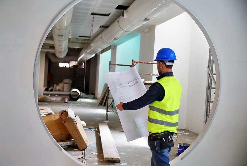 A construction worker reading blueprints.