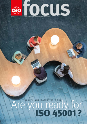 Business people sitting at a curved wooden desk.